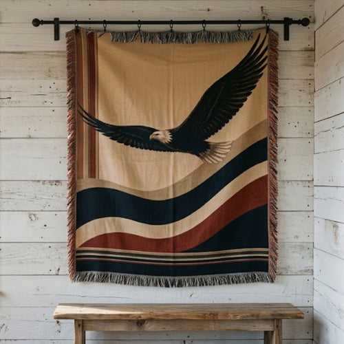 American Eagle woven cotton throw blanket hung on a whitewashed plank wall, bald eagle in flight, rust fringe