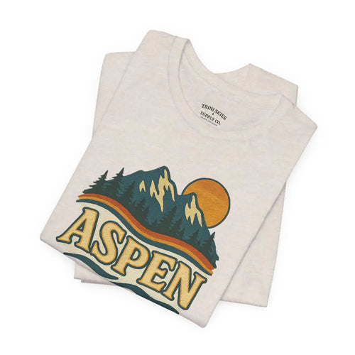 Folded off-white Aspen Lodge Tee with colorful mountain graphic and drawn design features