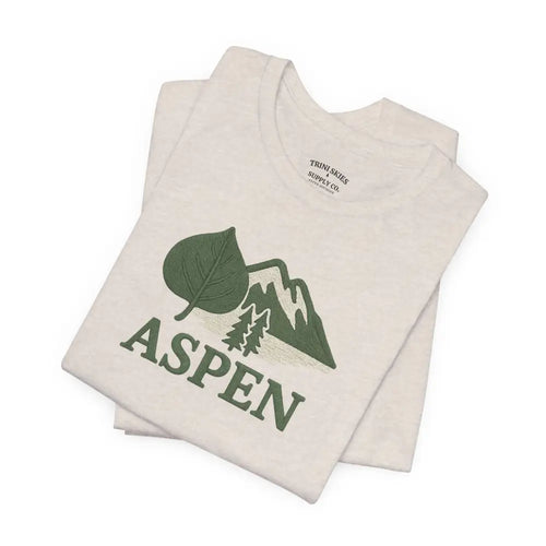Folded cream Aspen Mountain Tee with green Aspen design