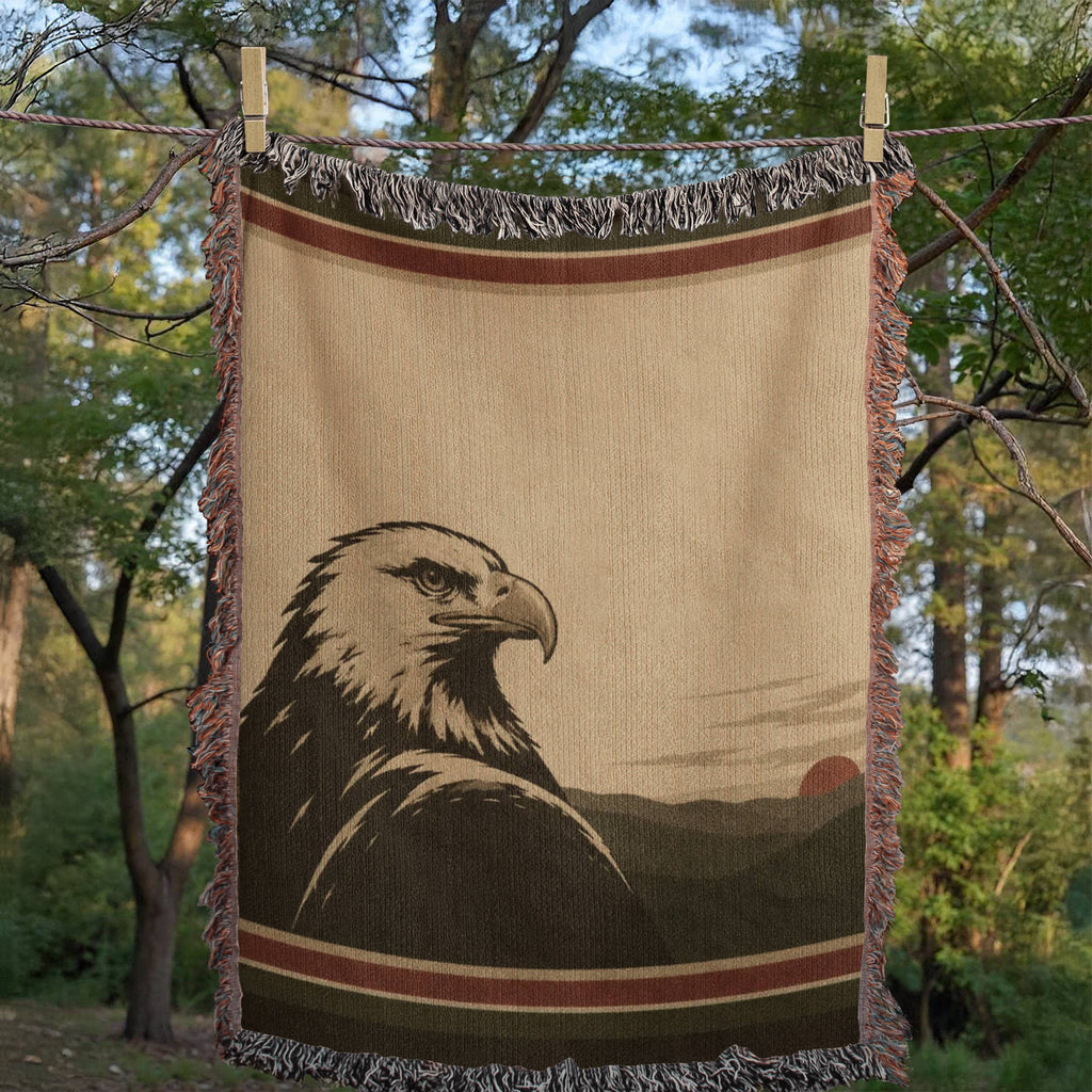Woman wrapped in The Sentinel bald eagle woven throw blanket on a mountain lodge balcony overlooking a lake — Trini Skies