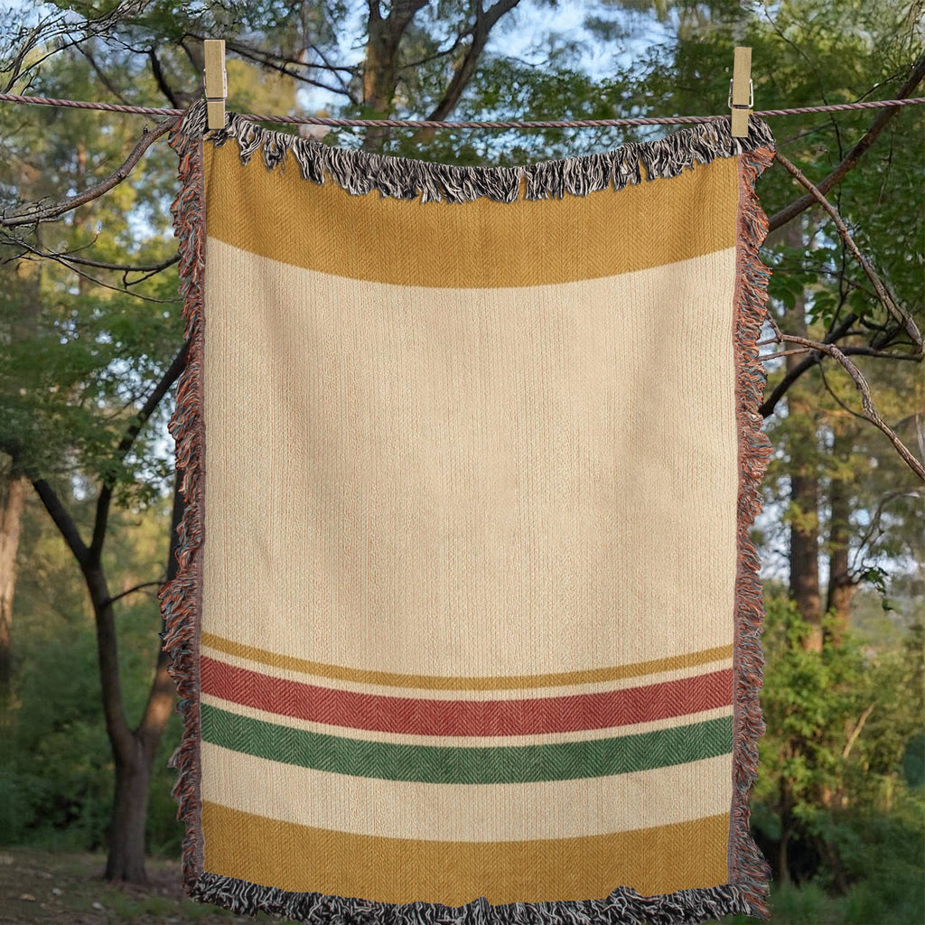 Magic Hour woven cotton throw blanket draped outdoors showing the honey-gold and red and green stripe detail — Trini Skies