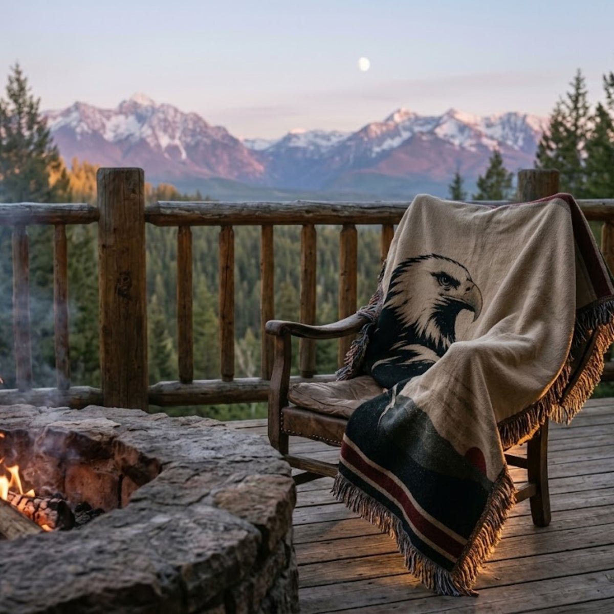 Bald eagle woven cotton throw over a rustic chair on a cabin deck by a fire pit, mountains and moon at dusk