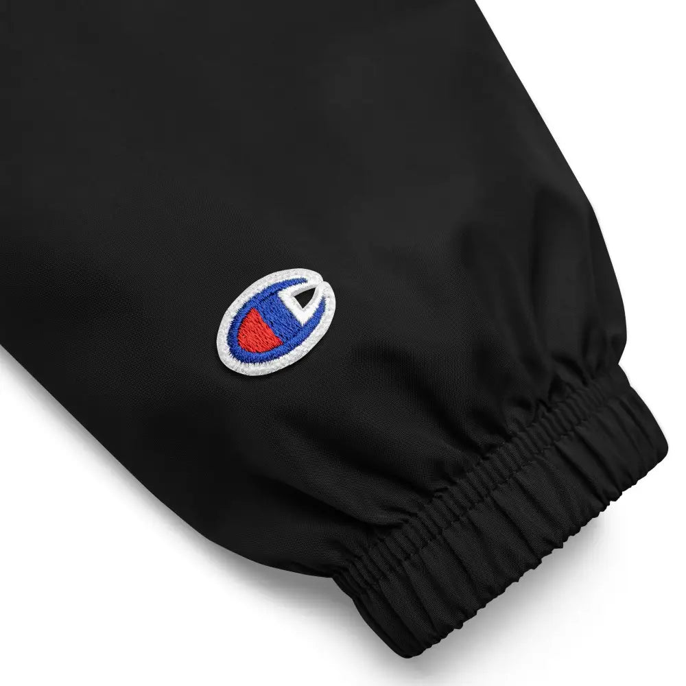 Black Champion logo on waterproof rain jacket sleeve for national park camping