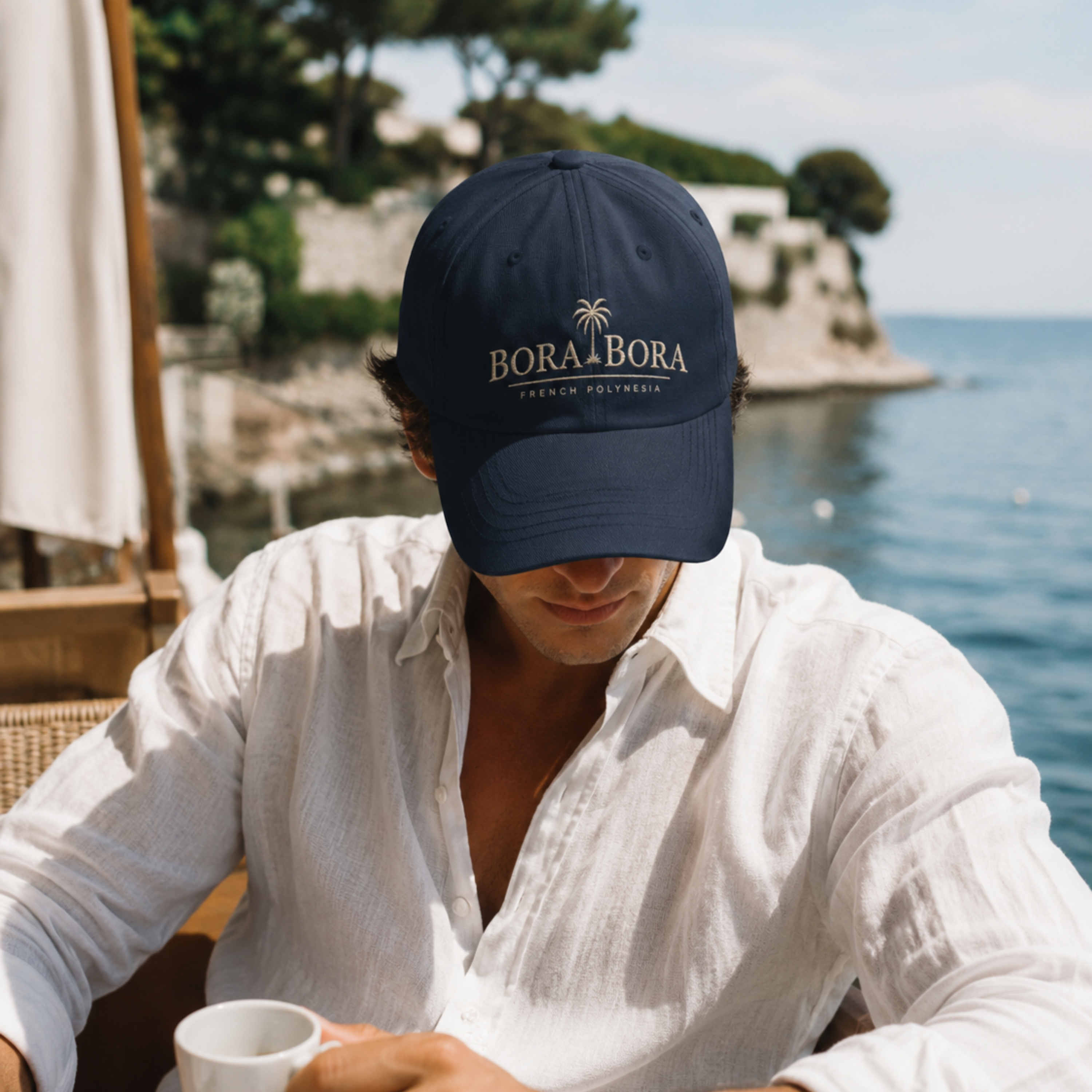 man wearing Navy Bora Bora French Polynesia embroidered dad hat side view on clean neutral background