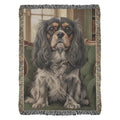 Woven cotton heritage blanket with Cavalier King Charles spaniel on green library chair