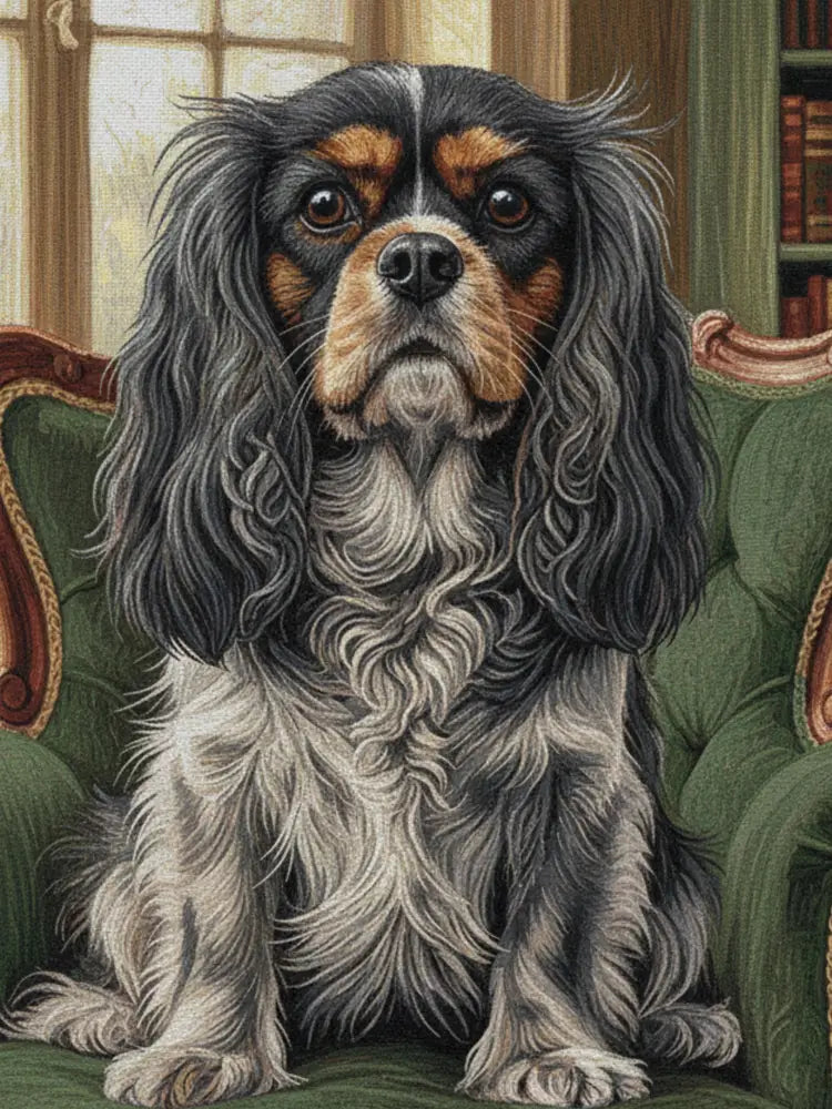 Regal Cavalier King Charles Spaniel on green library chair, woven cotton heritage blanket