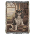 Cavalier King Charles Spaniel on green library chair in woven cotton heritage blanket