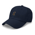Signature Monkey Embroidered Dad Hat by Trini Skies in navy cotton twill, left front view showing monkey emblem embroidery