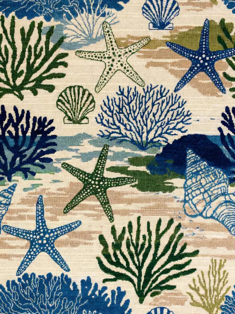 Coastal woven blanket with starfish coral pattern and fringe