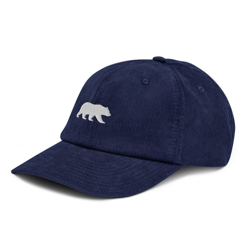 Oxford navy Big Sur Bear corduroy hat, front view, with a small cream embroidered walking bear emblem, Trini Skies
