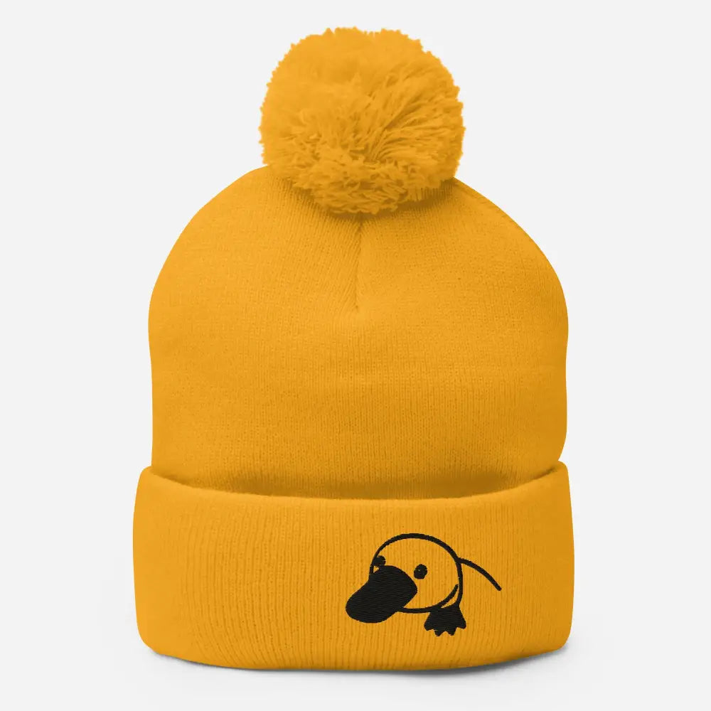 Cozy embroidered platypus pom-pom beanie in yellow knit