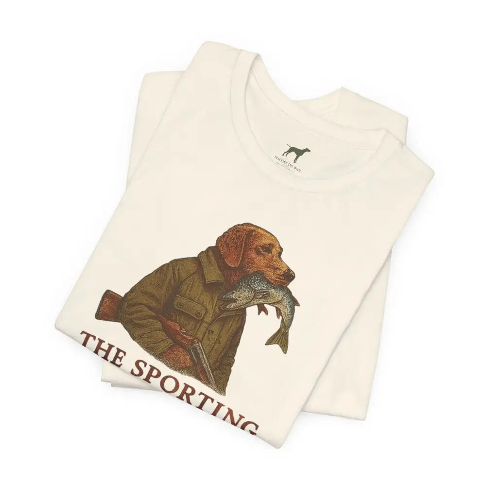 Folded cream tee with dog fishing graphic by Trini Skies Supply
