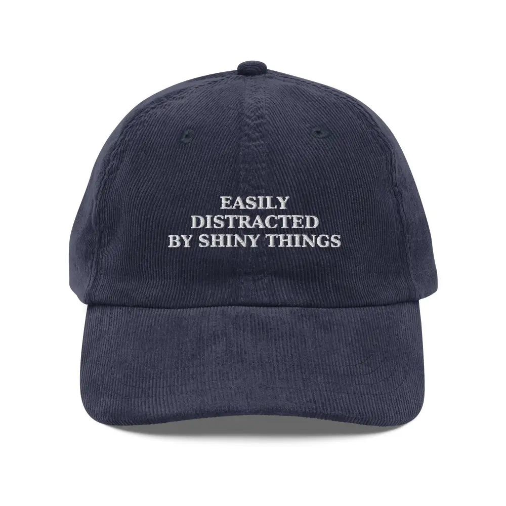 Dark blue corduroy baseball cap with white embroidered text