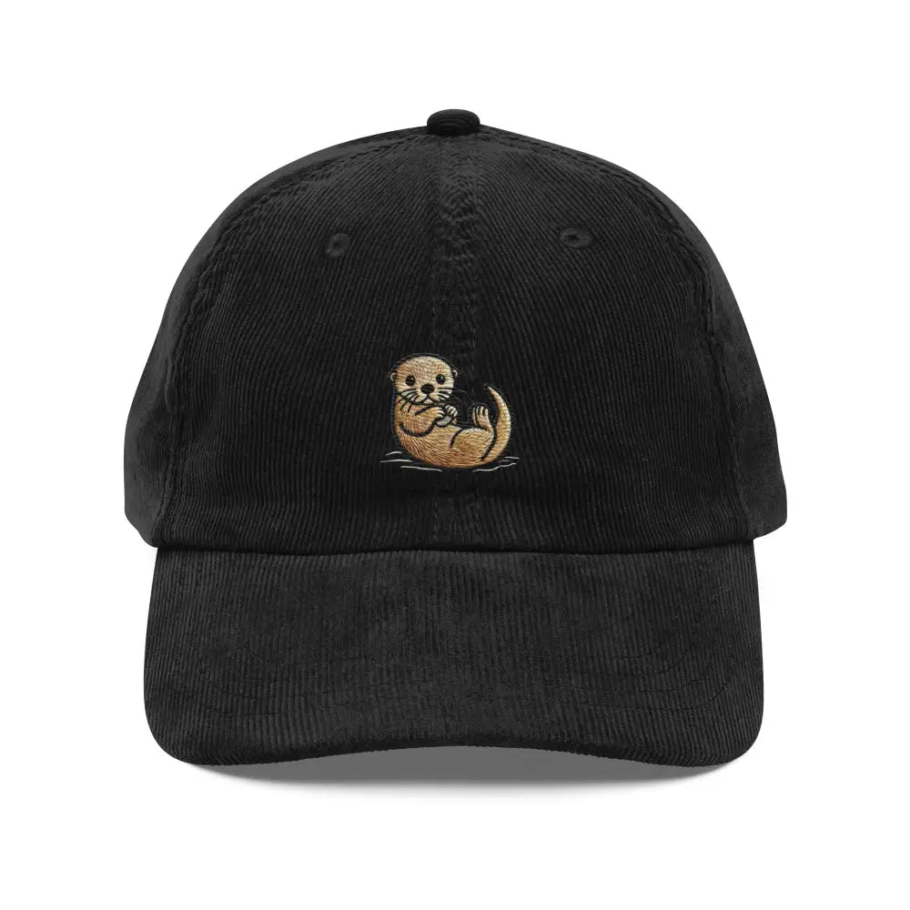 Embroidered otter hat in black corduroy, a little otter floating on its back on the front panel