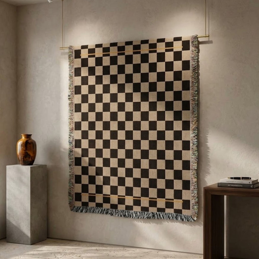 Espresso and oat checkerboard woven cotton throw blanket hanging as a tapestry showing full weave and gold hairline stripe detail