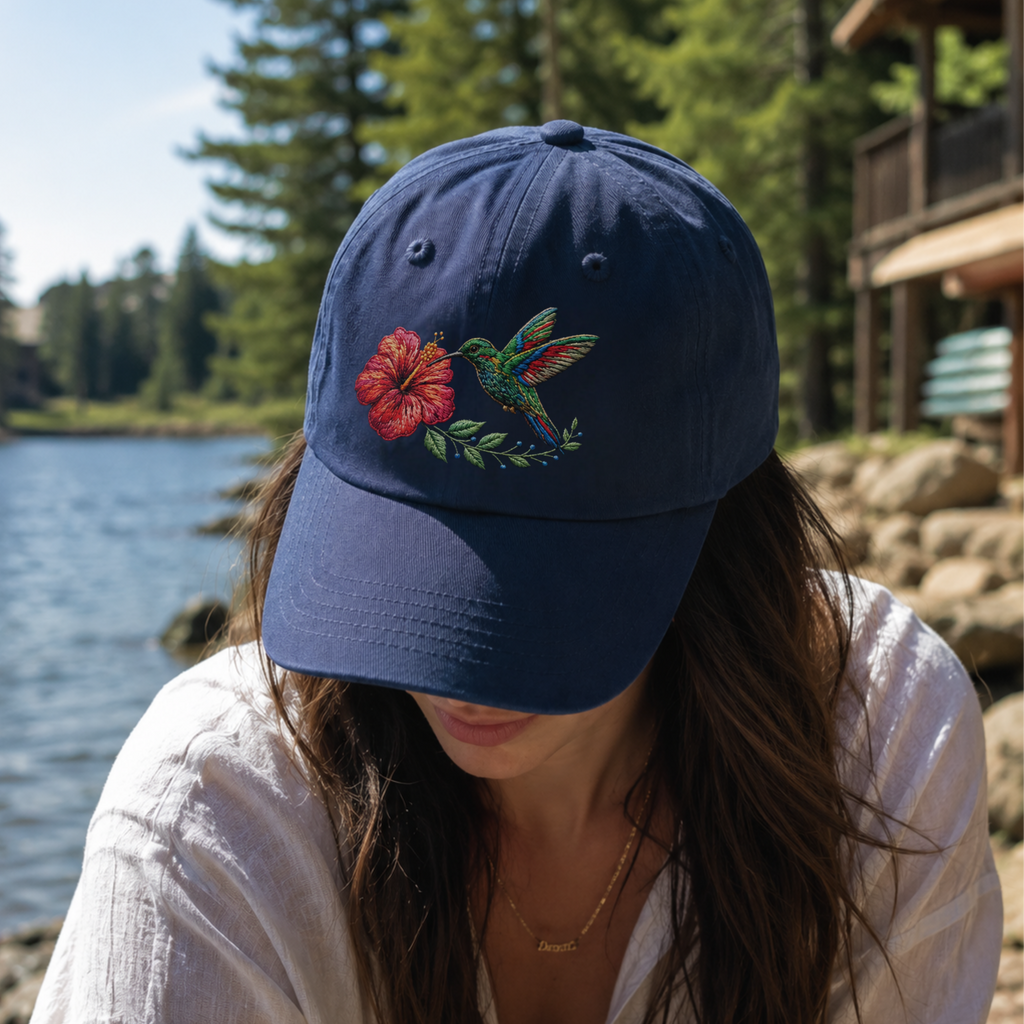 Woman wearing navy hummingbird embroidered dad hat coastal style