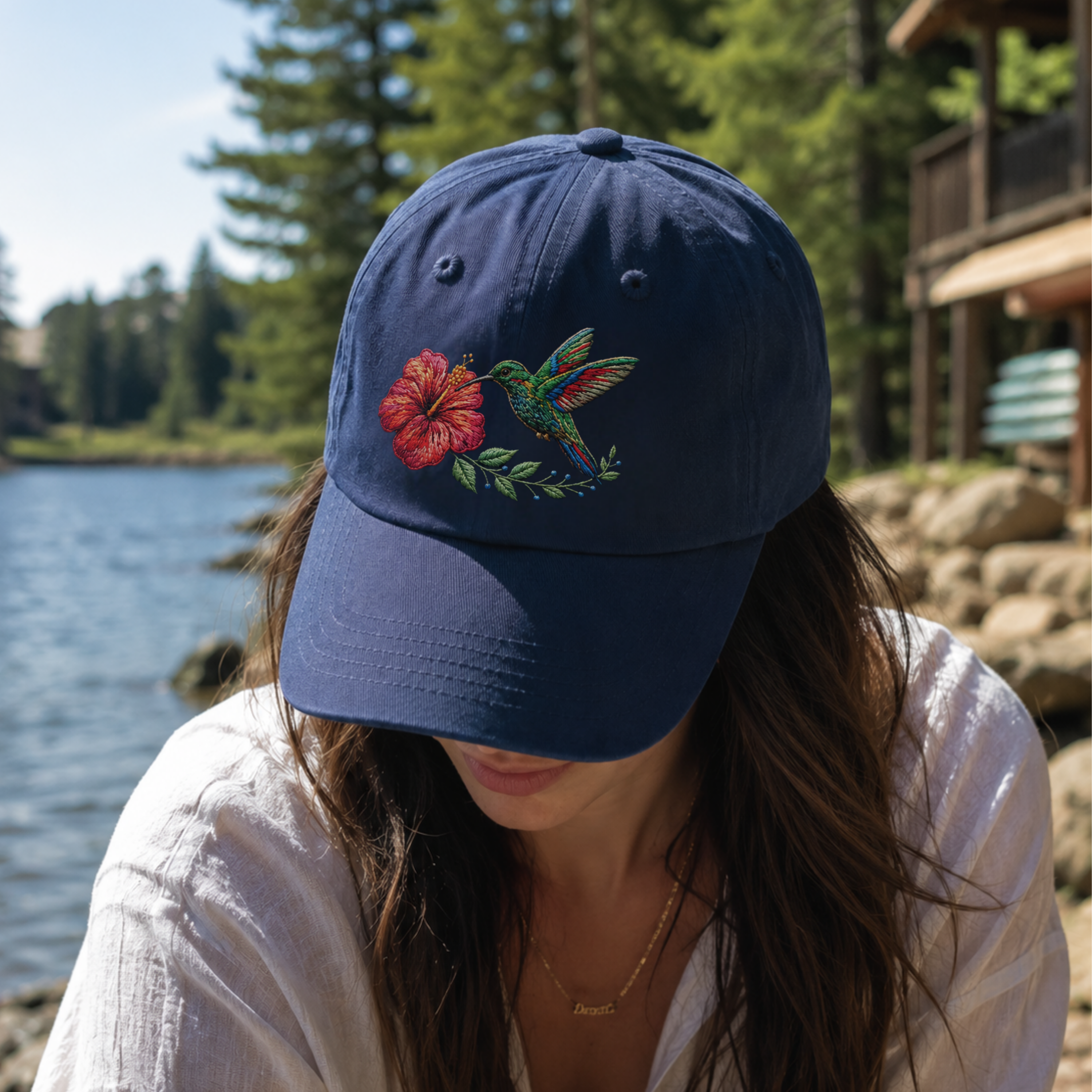 Woman wearing navy hummingbird embroidered dad hat coastal style