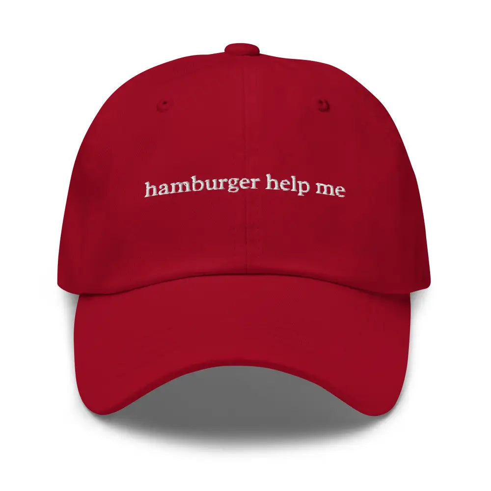 Red embroidered dad hat with white Trini Skies phrase on baseball cap