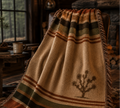 Joshua Tree woven cotton throw on leather armchair in lodge interior — southwestern heritage blanket by Trini Skies