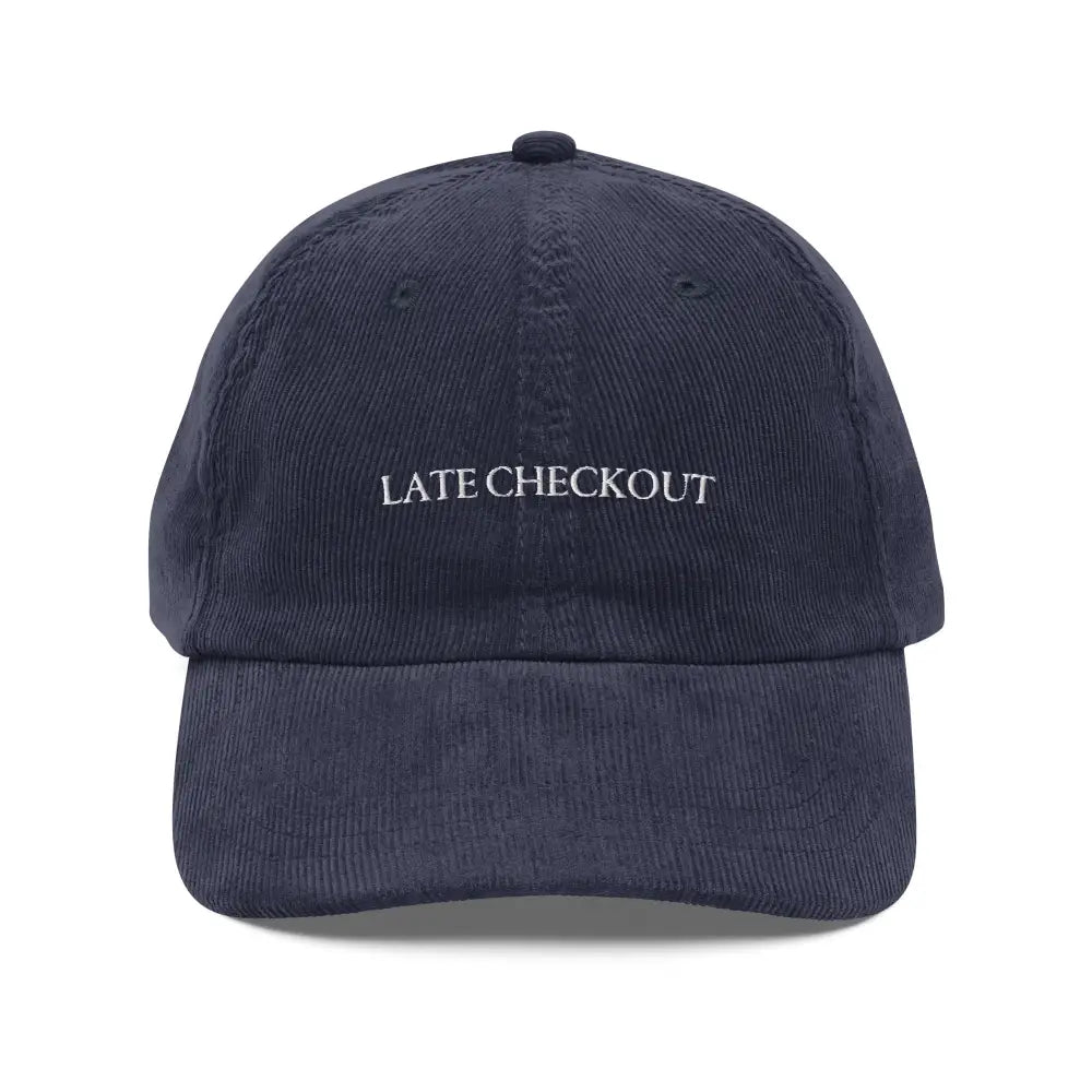 Navy blue corduroy dad cap with Late Checkout embroidery