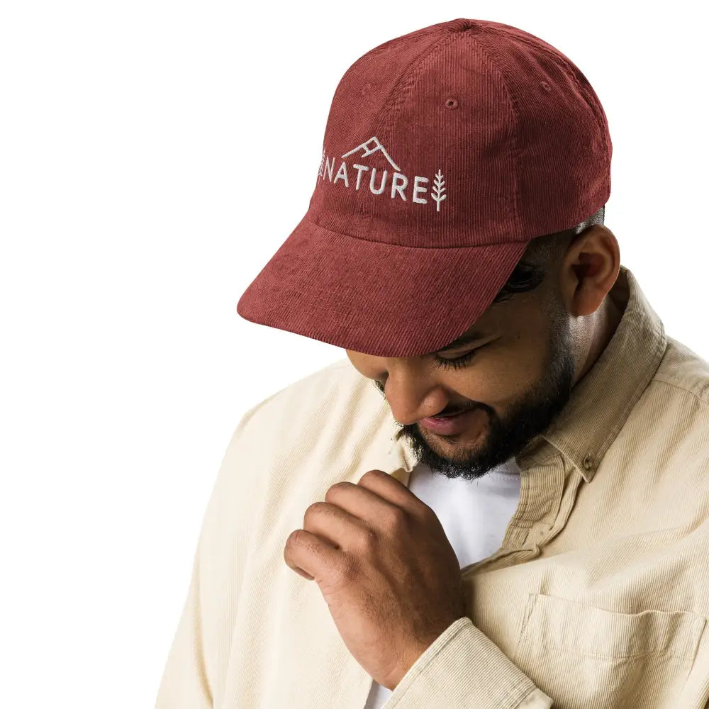 Red embroidered corduroy cap with NATURE mountain tree graphic