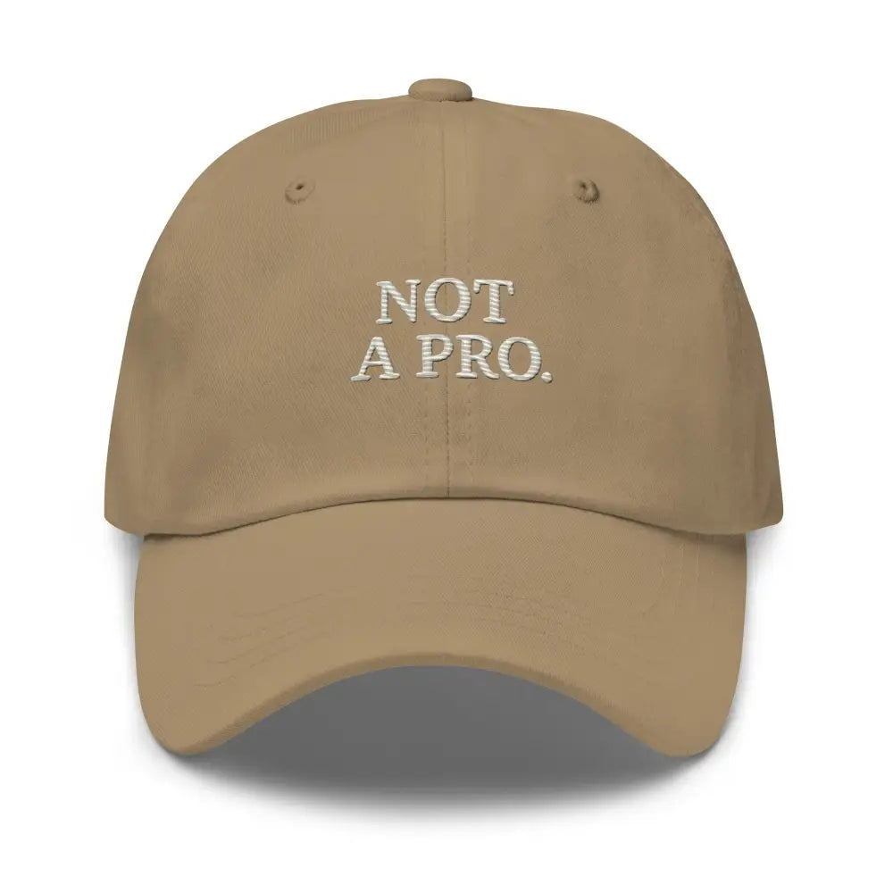 Tan minimalist dad hat with white embroidered Not a Pro Golf text