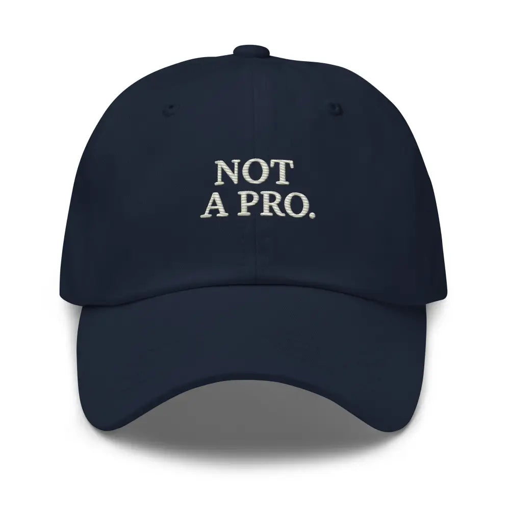 Navy blue minimalist dad hat with embroidered Not a Pro Golf text