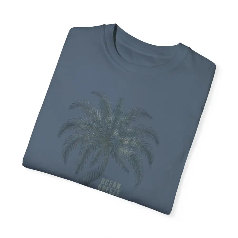 Folded blue ring-spun cotton t-shirt with palm tree graphic and Ocean Breeze text