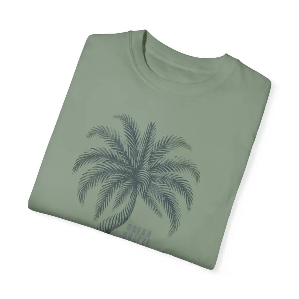 Folded sage green ring-spun cotton t-shirt with dark green palm tree graphic