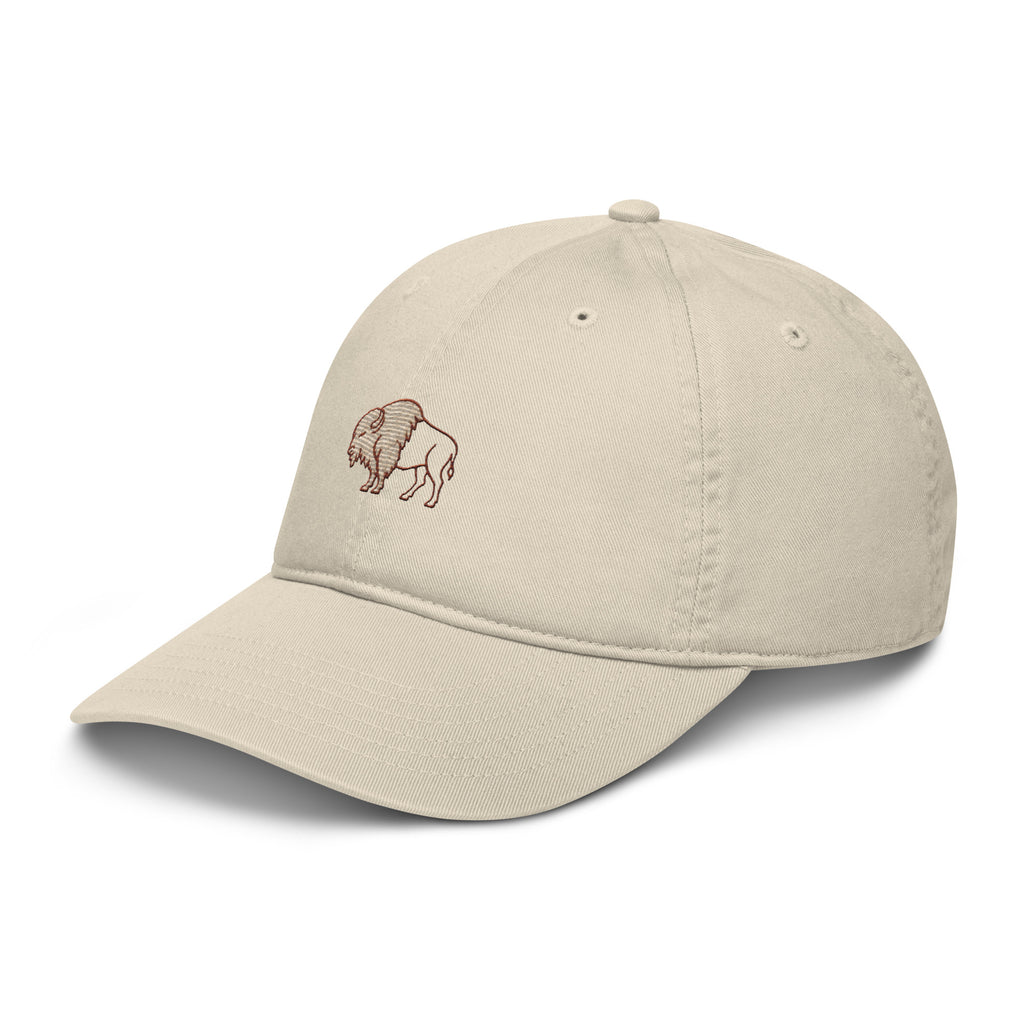 Heritage Bison Organic Cotton Hat in oyster stone — front left view showing split-fill bison embroidery in rust and cream on unstructured cotton dad hat
