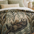 Pacific Sea Otter woven throw draped over a bed — jacquard cotton kelp forest tapestry blanket in a coastal bedroom setting