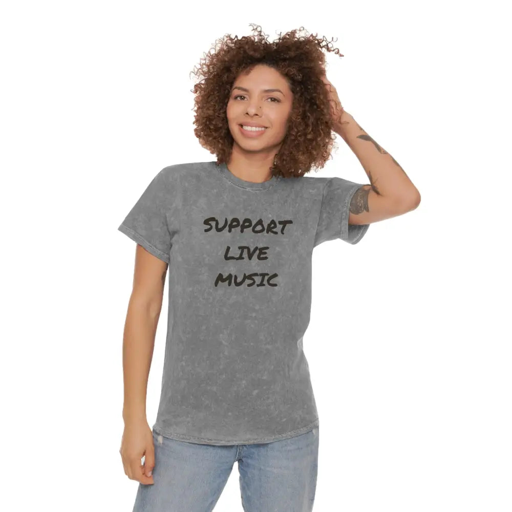 Smiling woman in gray Support Live Music tee and jeans from Trini Skies Underground Music Scene collection