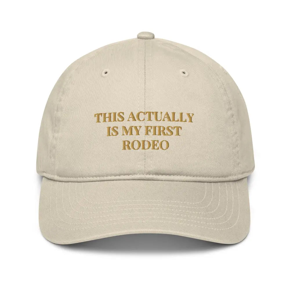Trini Skies embroidered organic dad hat with gold text on beige cap