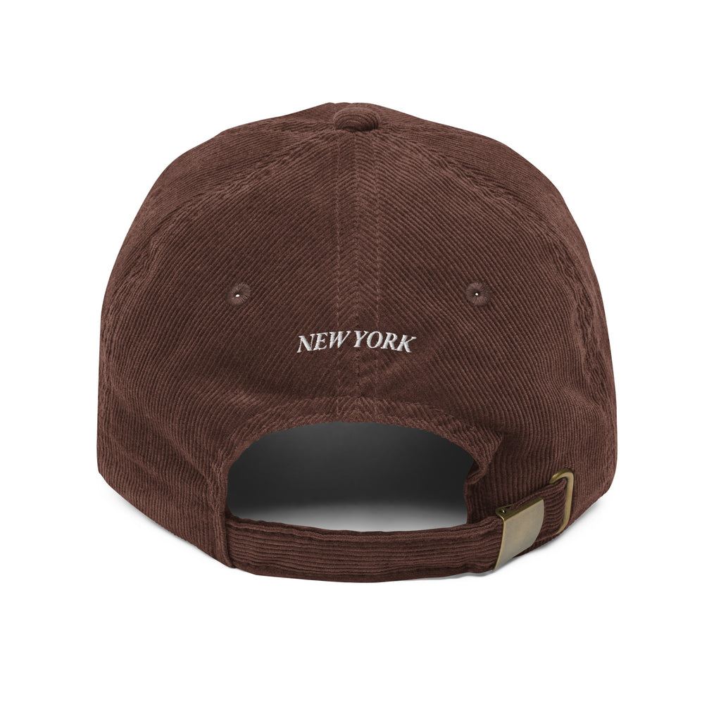 New York Carriage corduroy hat black back view New York text on adjustable strap Trini Skies