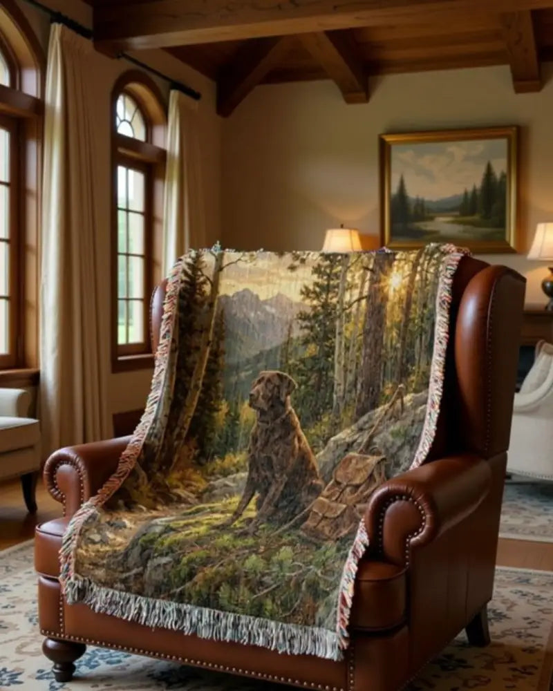Brown leather wingback armchair with wilderness labrador retriever woven throw