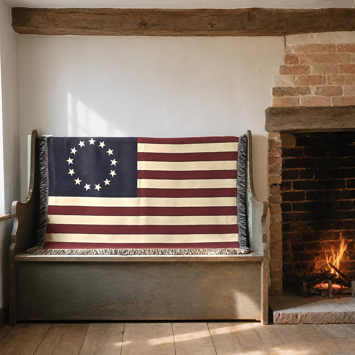 Betsy Ross flag woven throw on a painted colonial settle beside a brick hearth with a low fire