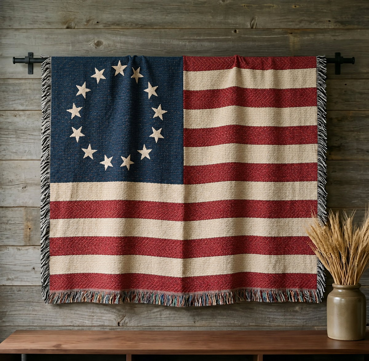 Betsy Ross 13-star flag woven cotton throw hung on a barnwood wall above a walnut console with dried wheat