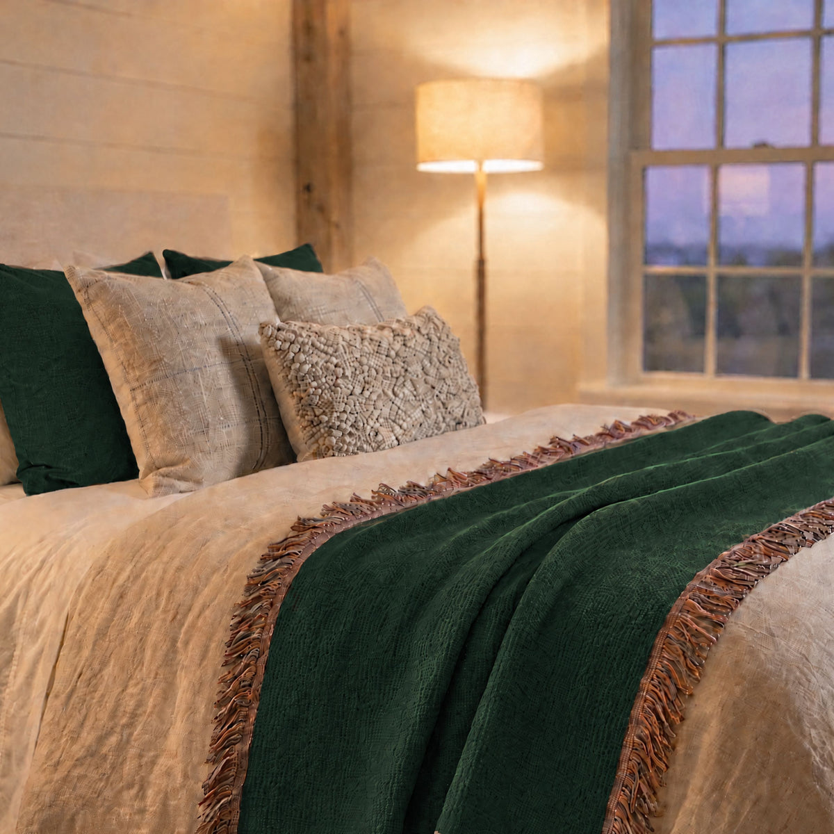 Solid forest green woven cotton throw blanket draped outdoors, showing the jacquard weave texture and fringe against a natural backdrop — Trini Skies